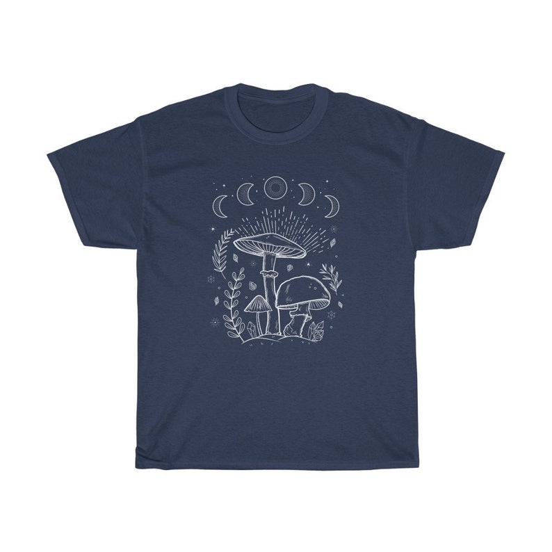 May include: Navy blue t-shirt featuring a white outline of mushrooms and a crescent moon design. The text "Shroom Queens" is printed on the shirt.