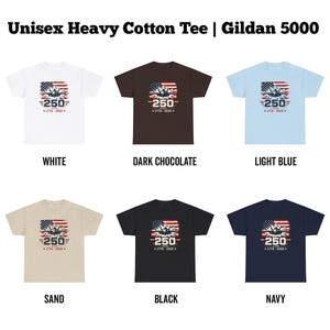 May include: Six different unisex heavy cotton tees with a graphic design. The design features an American flag, an airplane, and the text "250 Years 1776-2026". The shirts are available in white, dark chocolate, light blue, sand, black, and navy.