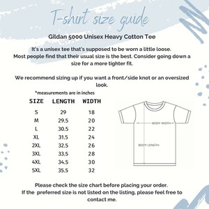 May include: T-shirt size guide for Gildan 5000 Unisex Heavy Cotton Tee.  The chart shows sizes from S to 5XL with corresponding length and width measurements in inches.  It's recommended to size up for a front/side knot or an oversized look.