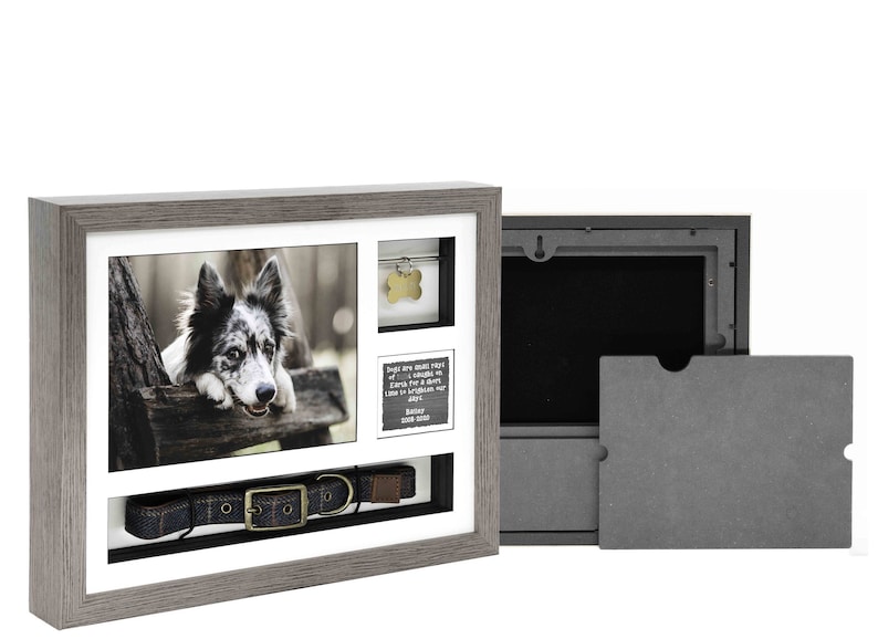 May include: A grey wooden shadow box with a photo of a dog, a dog collar, a dog tag, and a small inscription. The shadow box has a removable back panel for storing mementos.