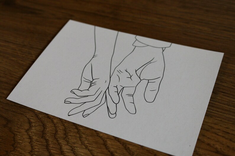 May include: A line drawing of two hands holding each other. The hands are drawn in a simple style, with no details of the fingers or nails.