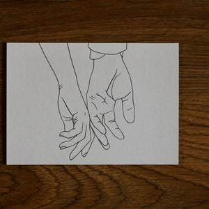 May include: A line drawing of two hands holding each other. The hands are drawn in a simple style, with no details of the fingers or nails.