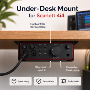 May include: Black under-desk mount for Scarlett 4i4 audio interface. The mount has a red trim and the text "Under-Desk Mount for Scarlett 4i4". Features include space-saving, secure mounting, and a clean cable-friendly setup.