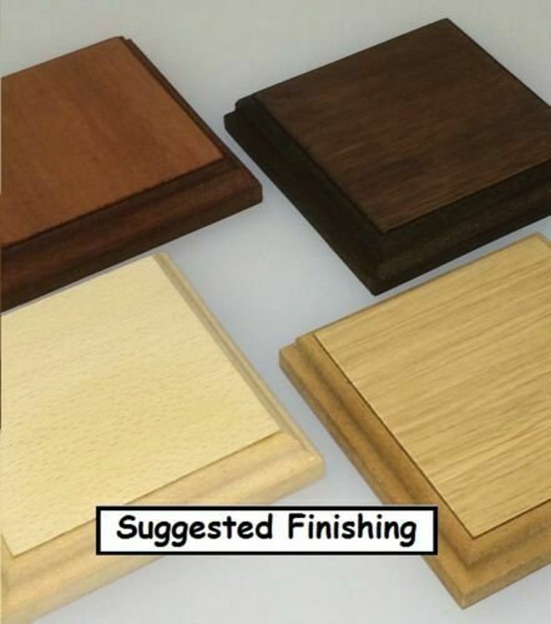 May include: Four wooden display bases in various finishes: light, medium, and dark brown, and natural wood. The bases are square with a layered design. The text "Suggested Finishing" is displayed in a white box at the bottom.