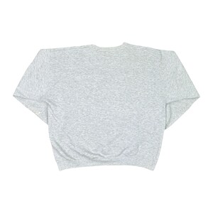 May include: A grey marl sweatshirt with a crew neck and long sleeves. The garment is made of a soft, comfortable material. The sweatshirt is a casual, everyday wear item.