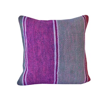 May include: A pink and gray striped throw pillow with a woven texture.
