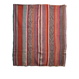May include: A rectangular woven textile with vertical stripes in shades of red, orange, green, and purple. The textile features a repeating diamond pattern in the center and is likely a blanket or throw.