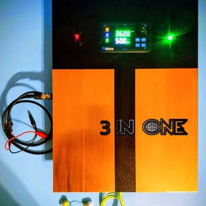 May include: A black and orange electronic device with the text "3 IN ONE". It has a digital display showing "36.00" and "500:". There are also two switches and a green light. Cables and yellow earbuds are connected to the device.