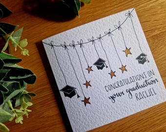 Hand painted watercolour graduation card - personalisation available, hanging mortarboard hats and stars, choose your greeting