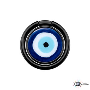 May include: Black phone ring holder with a blue and white evil eye design. The evil eye is a symbol of protection against negative energy.