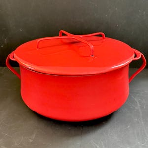May include: A bright red enamel cooking pot with a matching lid. The pot has two side handles and a handle on the lid. The pot is approximately 10 inches in diameter and 6 inches tall.