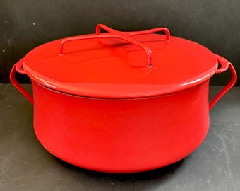 May include: A bright red enamel cooking pot with a matching lid. The pot has two side handles and a handle on the lid. The pot is approximately 10 inches in diameter and 6 inches tall.