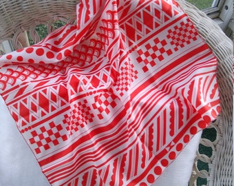 Vintage Scarf with a red-orange geometric design. Bold designs and colors.  The fabric is polyester. It is in perfect condition.