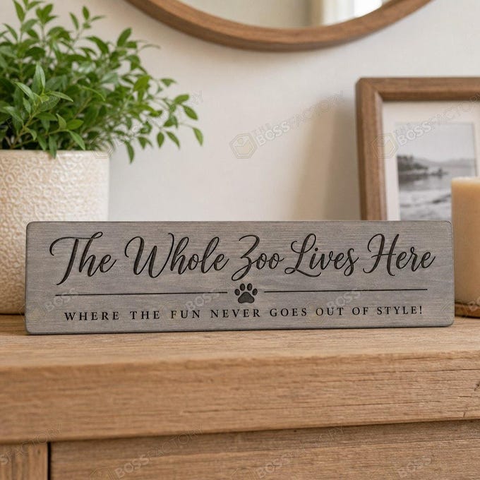 Laser-engraved family sign with the text 'The Whole Zoo Lives Here' and 'Where the fun never goes out of style!' displayed in weathered grey stain.
