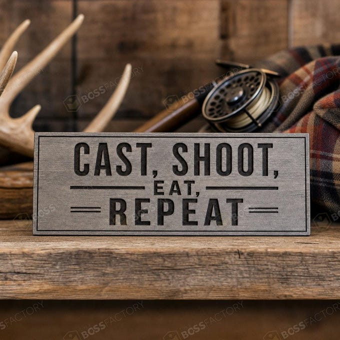 Laser-engraved hunting and fishing sign with the phrase 'Cast, Shoot, Eat, Repeat' on a weathered grey background.