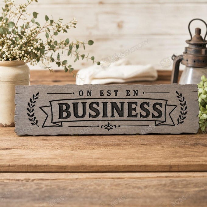 Laser-engraved solid pine office sign reading On Est En Business, shown with a Classic Grey stain option for business wall decor.