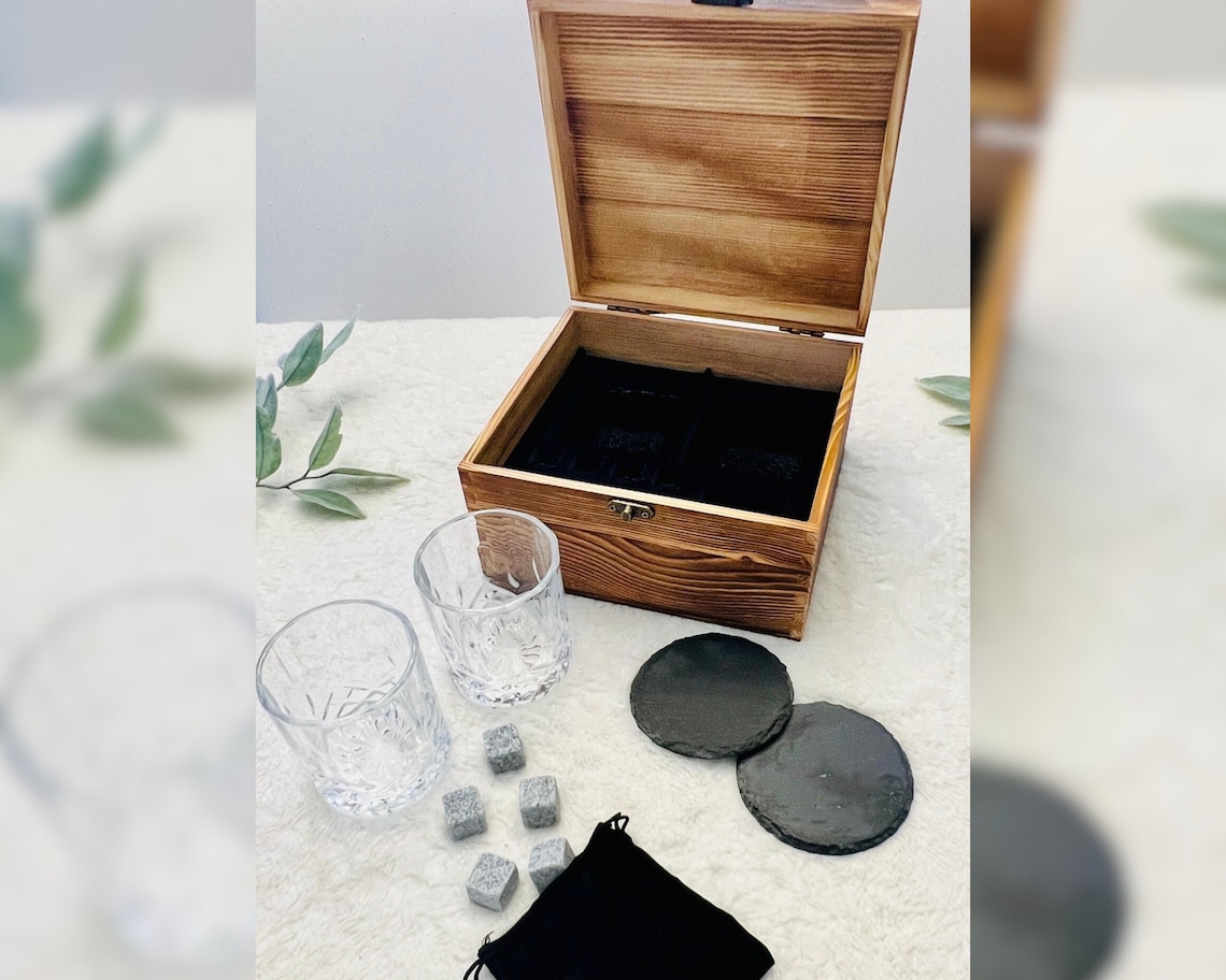 Engraved whiskey glasses set in a wooden presentation box