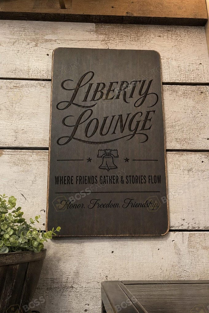 Laser-engraved man cave sign reading 'LIBERTY LOUNGE' with additional text, displayed in an ebony stain.