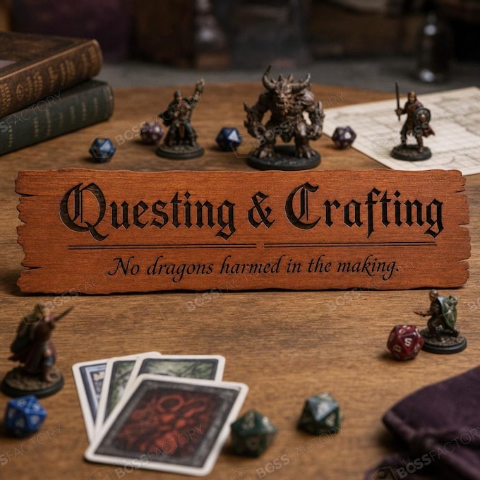 Laser-engraved gaming sign with 'Questing & Crafting' and 'No dragons harmed in the making' displayed in a game room.