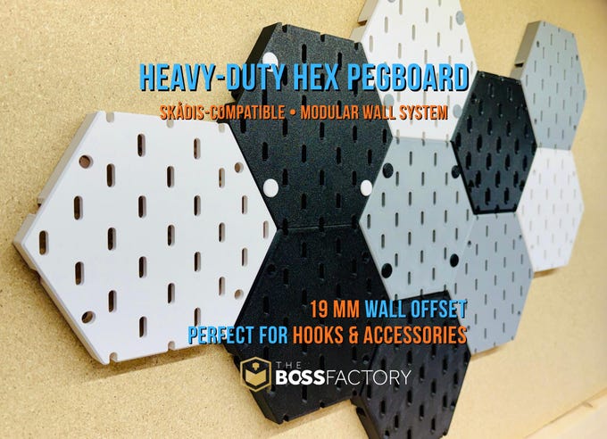 Heavy-duty hex pegboard tile system compatible with IKEA Skådis hooks, modular wall-mounted organizer in black, white, and gray