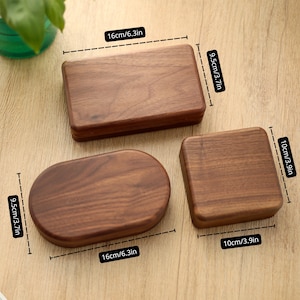 May include: Three wooden boxes in different shapes: a rectangle (6.3in x 3.7in), an oval (6.3in x 3.7in), and a square (3.9in x 3.9in). The boxes are made of a dark wood with visible grain. The boxes are on a light brown surface.