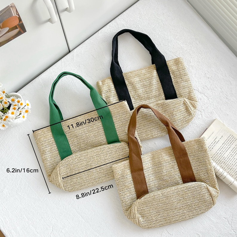 May include: Three woven tote bags with different colored handles. The bags are beige with green, black, and brown handles. The largest bag measures 11.8 inches (30 cm) wide and 6.2 inches (16 cm) high.