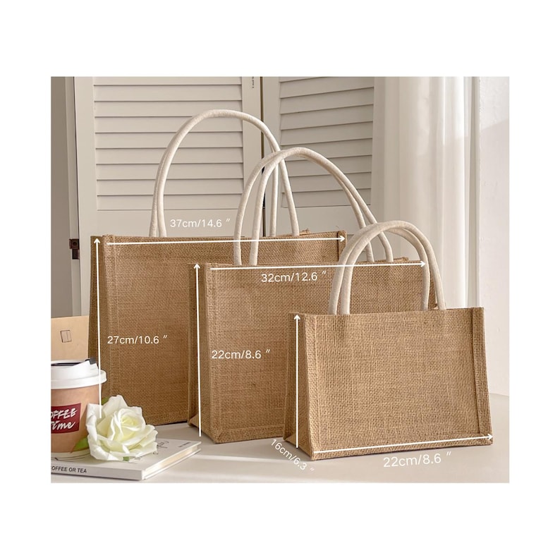 May include: Three rectangular jute tote bags with white handles are displayed. The largest bag is 37cm/14.6" wide and 27cm/10.6" tall. The medium bag is 32cm/12.6" wide and the smallest is 22cm/8.6" wide and 16cm/6.3" tall.