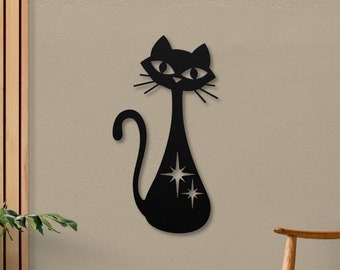 May include: Black metal wall decor featuring a stylized cat with a long tail and large eyes. The cat has a cutout design of stars on its body.