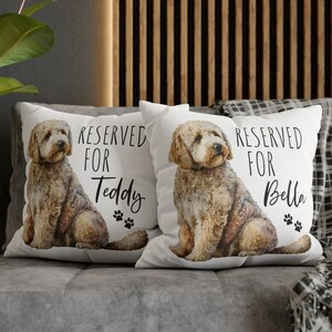 May include: Two white throw pillows with a watercolor illustration of a brown and white dog on each pillow. The text "RESERVED FOR" is printed on each pillow, with the name "Teddy" on one pillow and "Bella" on the other.