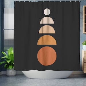 May include: Black shower curtain with a geometric design. The design features a stack of shapes in white, beige, and orange hues. The shapes include a circle, semi-circles, and a full circle. The curtain is hanging in a bathroom setting.