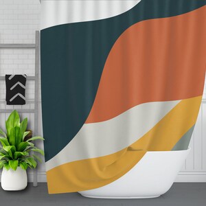 May include: A shower curtain with a geometric pattern in shades of teal, orange, yellow, and white. The curtain is made of fabric and has a wavy design.