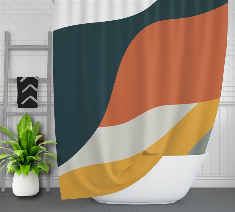 May include: A shower curtain with a geometric pattern in shades of teal, orange, yellow, and white. The curtain is made of fabric and has a wavy design.