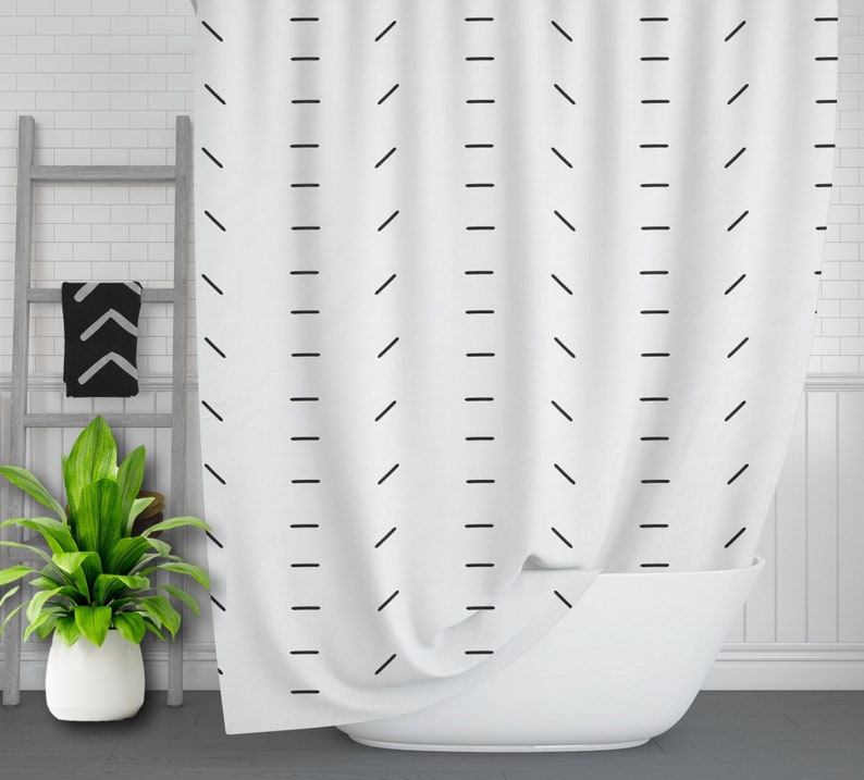 May include: White shower curtain with a black geometric pattern of diagonal and horizontal lines.