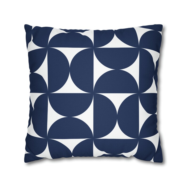 May include: A navy blue and white geometric cushion with a repeating pattern of semi-circles.