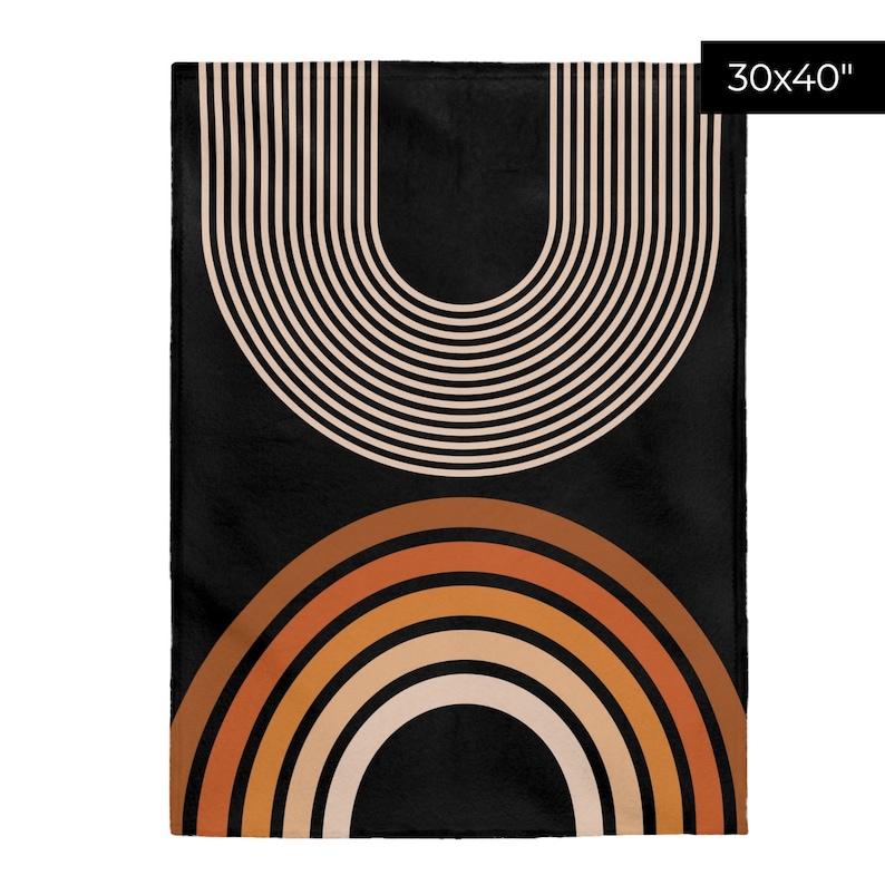 May include: A black throw blanket with a geometric design featuring two sets of concentric arches in beige, orange, and brown. The blanket measures 30x40 inches.