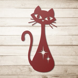 May include: A red silhouette of a cat with a starburst design on its body. The cat is facing forward with its tail curled around its body.