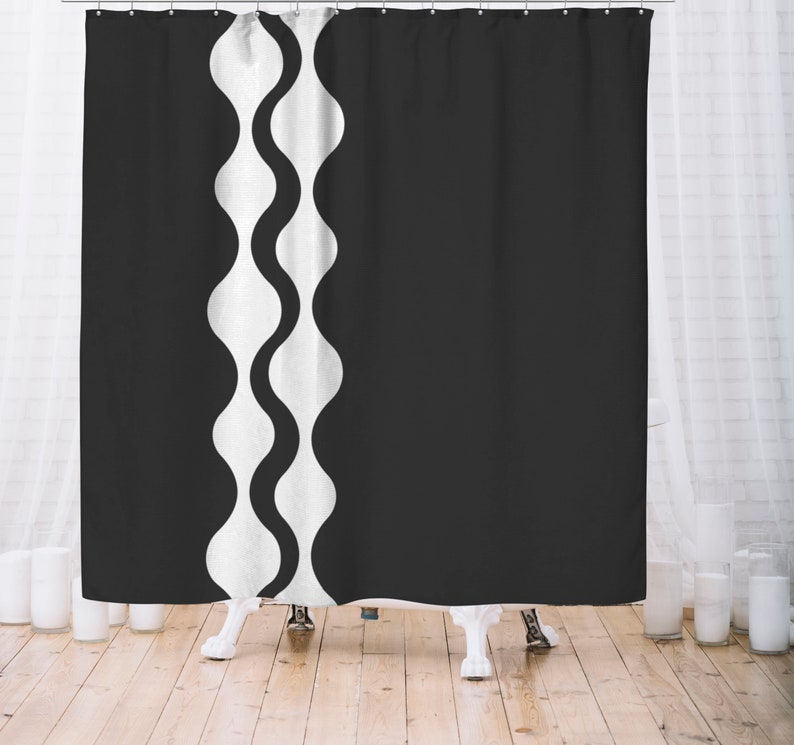 May include: Black and white shower curtain with a wavy pattern on the left side.