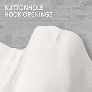 May include: Close-up of a white fabric curtain panel with a buttonhole hook opening. The text "BUTTONHOLE HOOK OPENINGS" is visible at the top of the image.