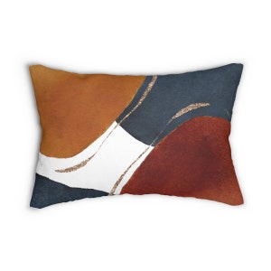 May include: A decorative throw pillow with an abstract design featuring overlapping circles in shades of rust, burnt orange, navy blue, and burgundy with gold accents.