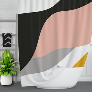 May include: A shower curtain with a geometric design featuring black, pink, gray, and yellow colors. The curtain is made of fabric and has a wavy pattern.