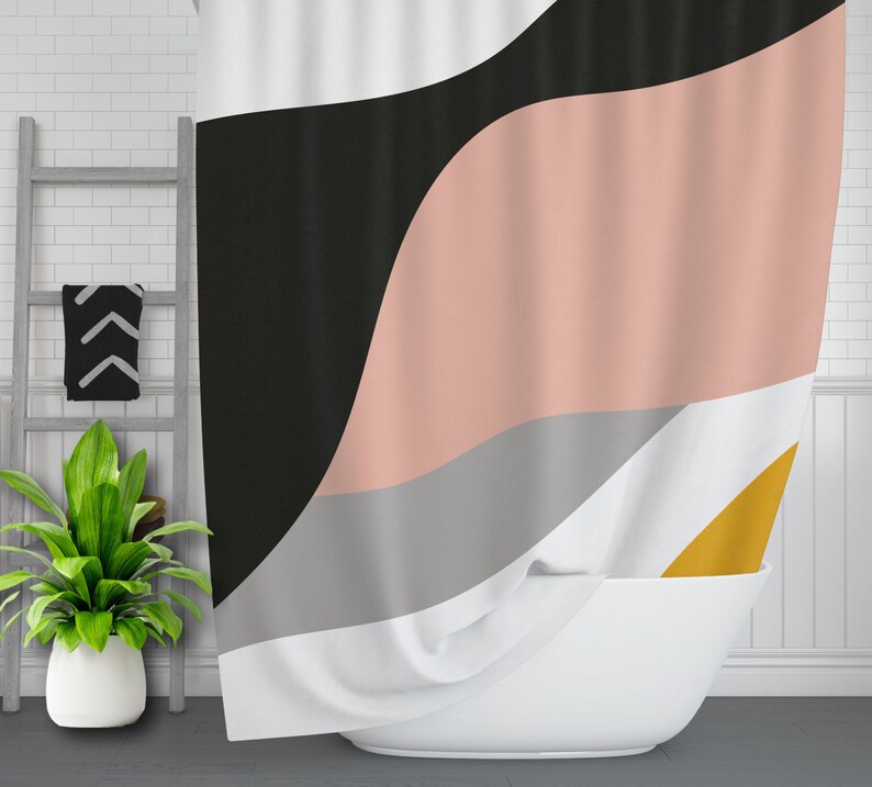 May include: A shower curtain with a geometric design featuring black, pink, gray, and yellow colors. The curtain is made of fabric and has a wavy pattern.