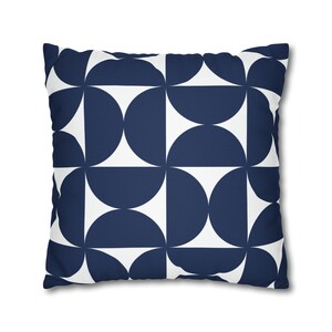 May include: A navy blue and white geometric patterned cushion. The cushion features a repeating pattern of semi-circles.