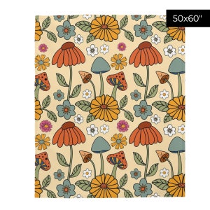 May include: A beige blanket with a repeating pattern of orange, yellow, and blue flowers, mushrooms, and leaves. The blanket measures 50x60 inches.