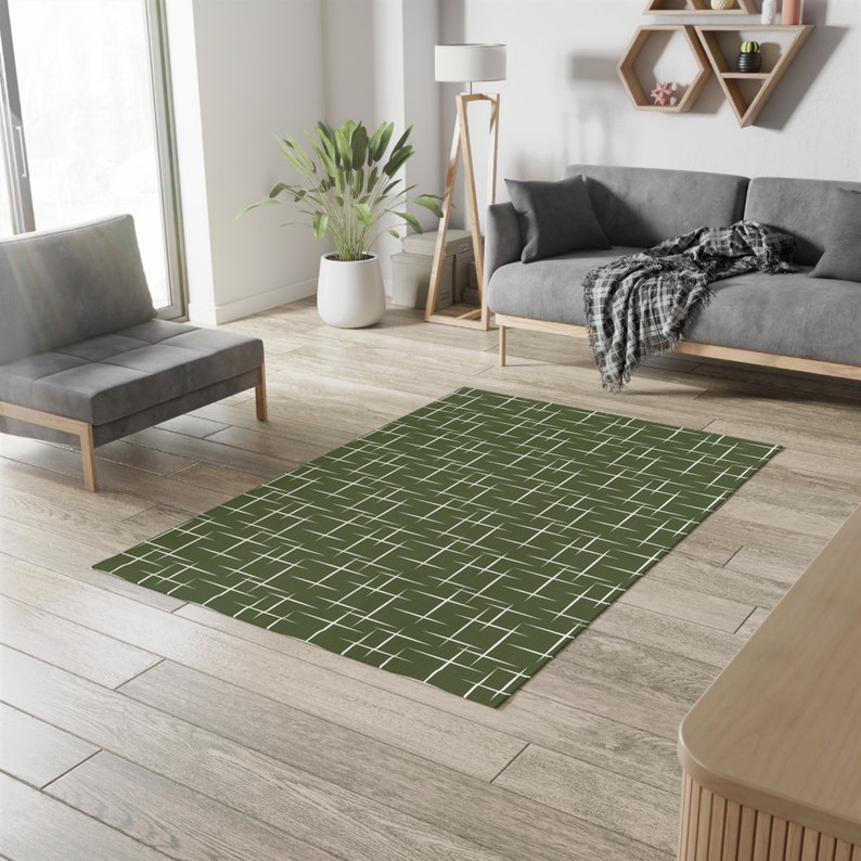 May include: A green and white geometric patterned area rug with a white background and green lines.