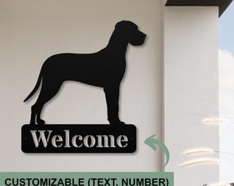 May include: Black metal silhouette of a Great Dane dog standing on a metal sign that says "Welcome". The sign is customizable with text or numbers.