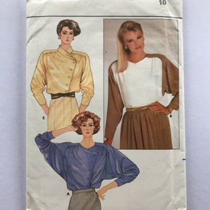 May include: Vintage sewing pattern for a women's blouse with three different styles. The pattern is from Butterick and is size 10. The pattern is for a blouse with a button-up front and long sleeves.