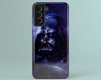May include: A phone case with a design of Darth Vader set against a backdrop of a starry space. The case is mainly dark blue with a glossy finish, displaying the iconic helmet and a distant planet. The phone case has a black border and a camera array.