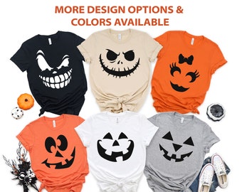 May include: A collection of Halloween-themed t-shirts in various colors, including black, beige, orange, white, and gray. Each shirt features a different jack-o'-lantern face design in black. The text "MORE DESIGN OPTIONS & COLORS AVAILABLE" is at the top.