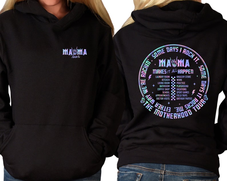 May include: Black hooded sweatshirt with a holographic design. The front of the sweatshirt says "Mama Tour" with a rock and roll hand gesture. The back of the sweatshirt says "Some days I rock it. Some days it rocks me. We're rockin' the motherhood tour. Mama makes it all happen." with a list of activities like laundry, kitchen, work, practice, playground, holidays, school, appointments, doctor visits, grocery store, and birthday parties.