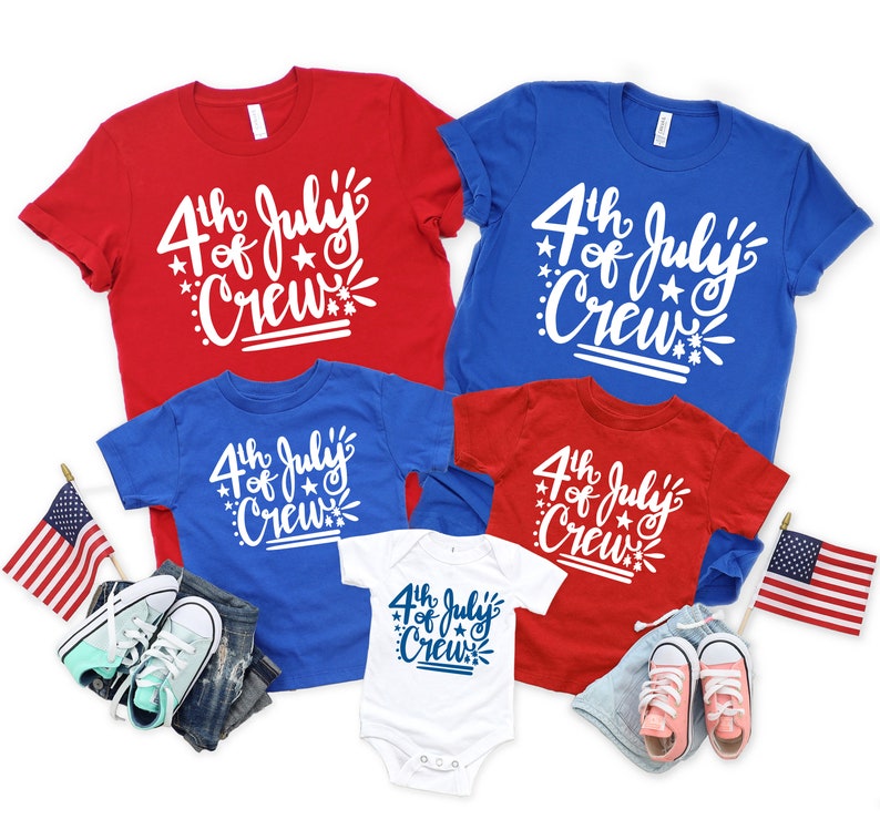 May include: Red, white, and blue t-shirts and a white onesie with the text "4th of July Crew". The image includes children's clothing, shoes, and American flags, perfect for Independence Day celebrations.